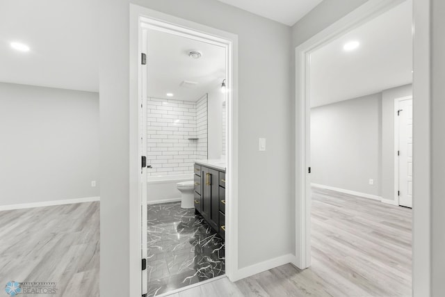 full bathroom with baseboards, recessed lighting, vanity, and wood finished floors