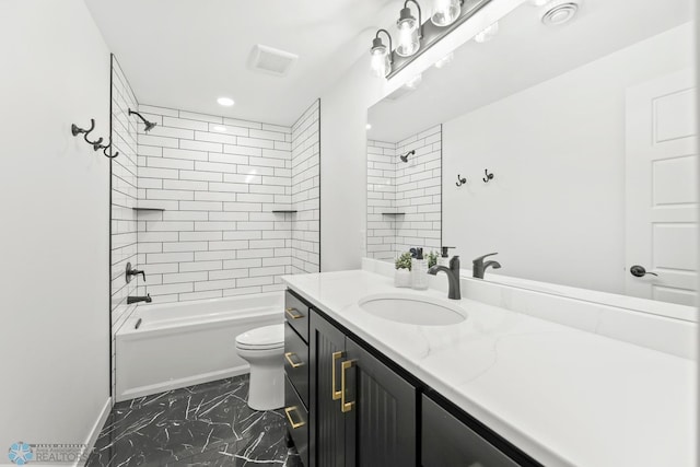 bathroom featuring marble look tiles, toilet, vanity, and shower / tub combination