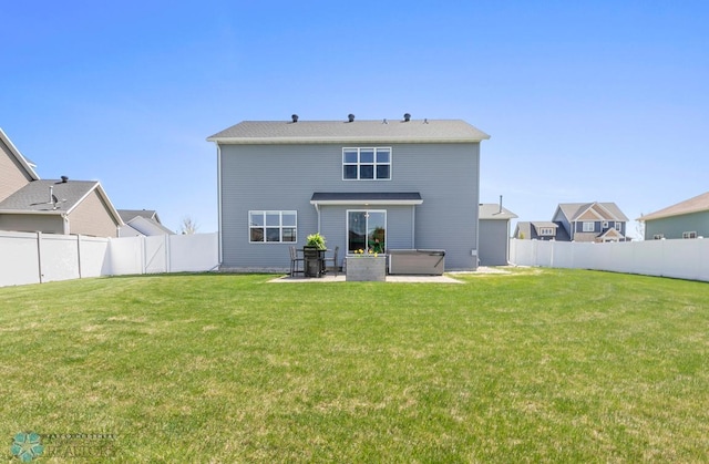 back of property with a hot tub and a patio