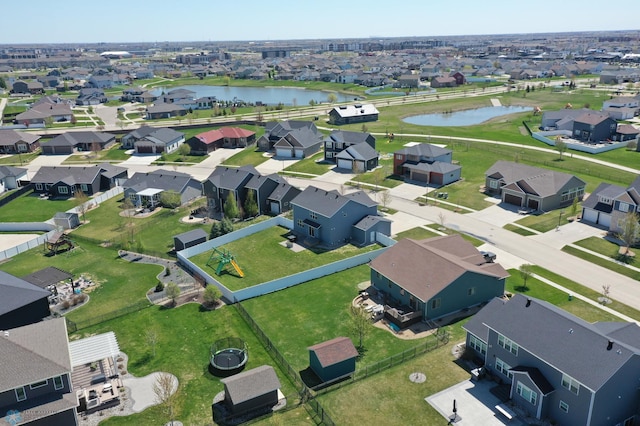 aerial view of property and surrounding area with a large body of water and nearby suburban area