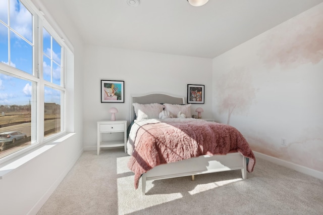 bedroom with multiple windows, carpet floors, and baseboards