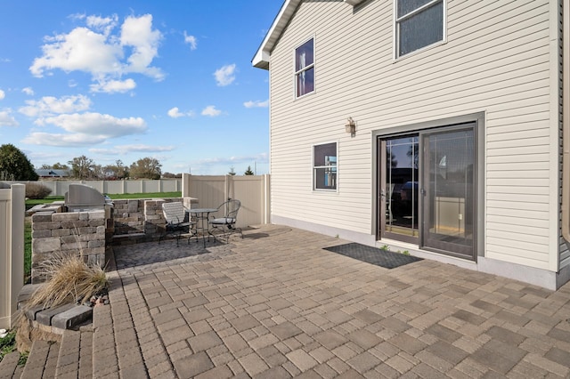 view of patio featuring fence, outdoor dining area, and area for grilling