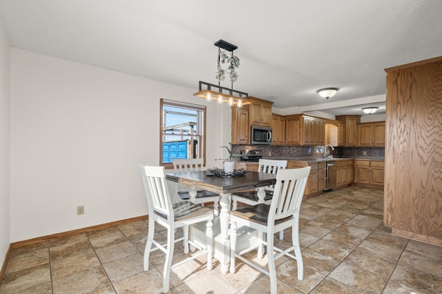 dining space featuring baseboards