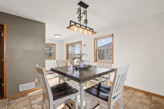 dining room featuring baseboards and visible vents