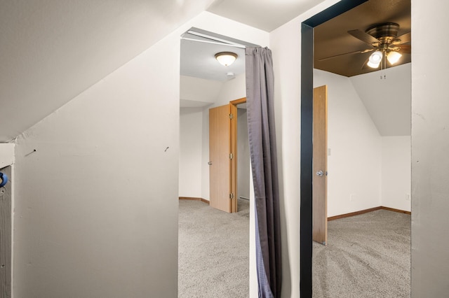 additional living space featuring a ceiling fan, baseboards, vaulted ceiling, and light carpet