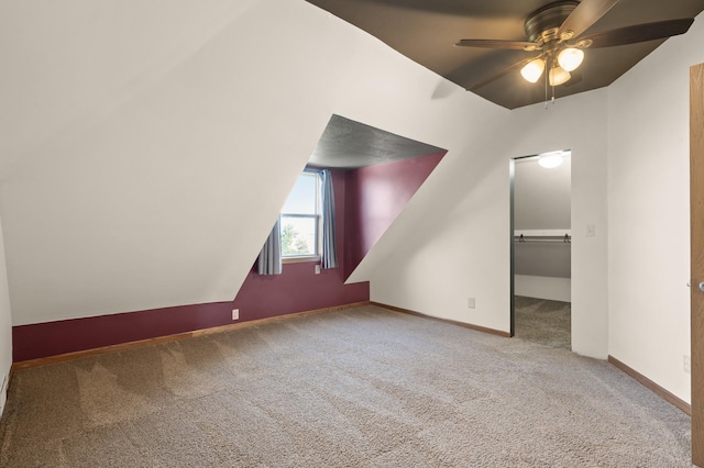 bonus room featuring carpet floors, a ceiling fan, baseboards, and vaulted ceiling