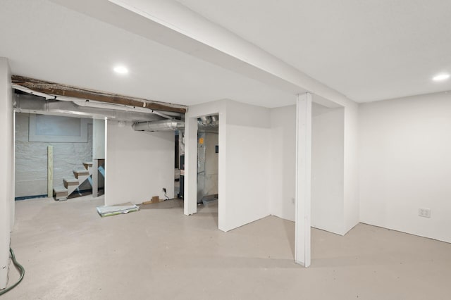 finished below grade area with recessed lighting and stairs