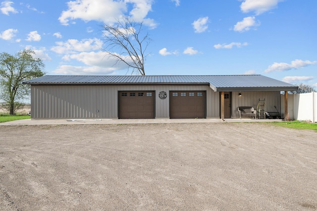 detached garage featuring fence