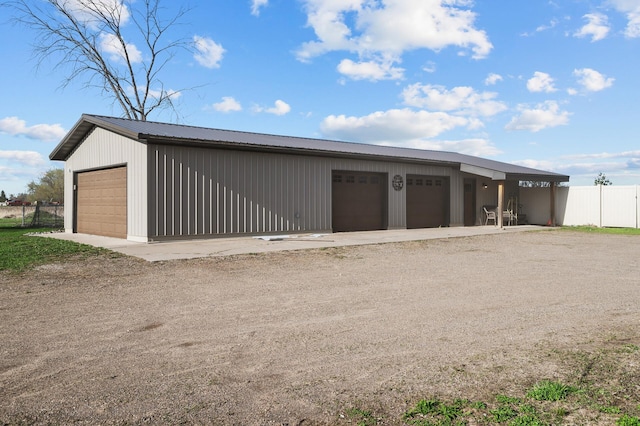 detached garage featuring fence