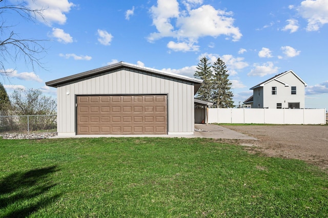 detached garage featuring fence