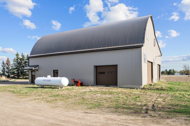 exterior space featuring metal roof, an outdoor structure, and a garage