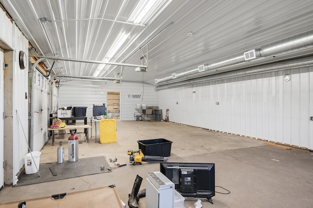 garage featuring a garage door opener and visible vents
