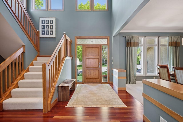 4970 Yuma Ct N, Plymouth, MN 55446 - foyer entrance featuring stairway, dark wood-type flooring, baseboards, a towering ceiling, and crown molding