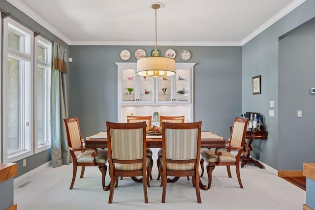4970 Yuma Ct N, Plymouth, MN 55446 - dining area with baseboards, crown molding, and carpet floors