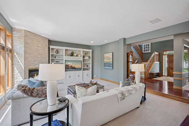 4970 Yuma Ct N, Plymouth, MN 55446 - living room with stairway, baseboards, a stone fireplace, and light wood-style floors