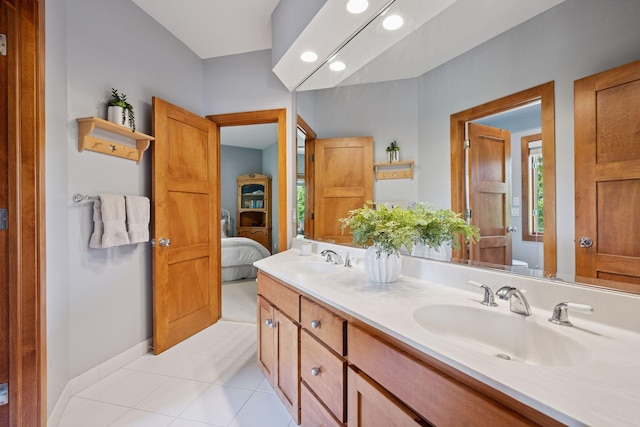 4970 Yuma Ct N, Plymouth, MN 55446 - ensuite bathroom featuring double vanity, tile patterned flooring, and baseboards