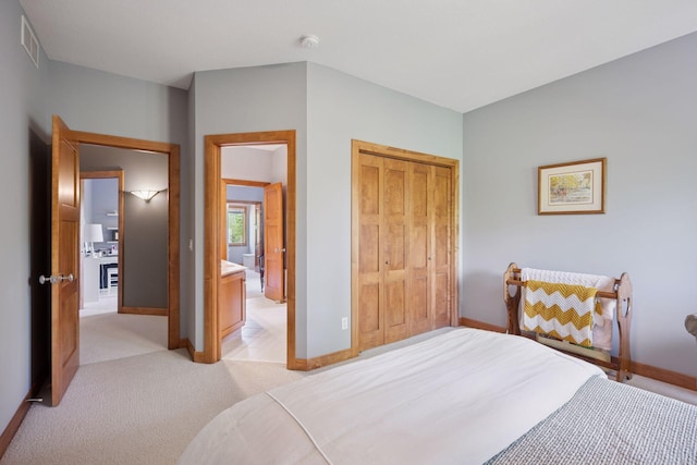4970 Yuma Ct N, Plymouth, MN 55446 - bedroom featuring baseboards, light colored carpet, and a closet