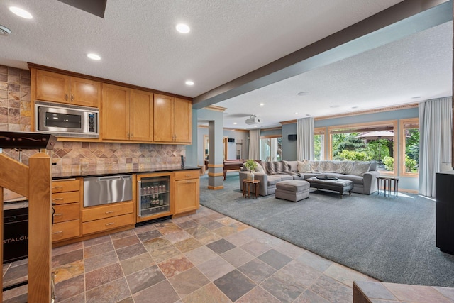 4970 Yuma Ct N, Plymouth, MN 55446 - kitchen featuring beverage cooler, stainless steel microwave, a warming drawer, a textured ceiling, and dark countertops