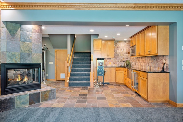 4970 Yuma Ct N, Plymouth, MN 55446 - kitchen featuring stainless steel microwave, wine cooler, baseboards, stone finish flooring, and dark countertops