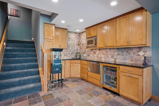 4970 Yuma Ct N, Plymouth, MN 55446 - kitchen with wine cooler, stainless steel appliances, dark stone finish floors, recessed lighting, and tasteful backsplash
