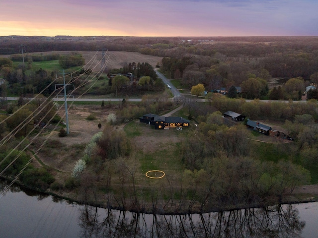 aerial view at dusk with a rural view and a water view