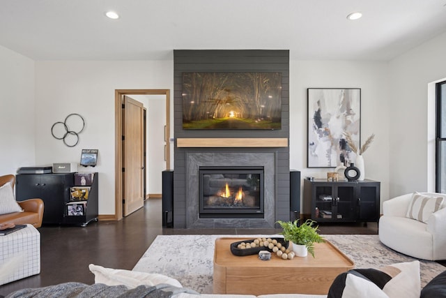 living room with a fireplace, baseboards, and recessed lighting