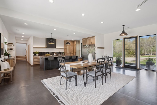 dining room with stairs, finished concrete flooring, and recessed lighting