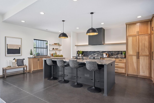 kitchen with a breakfast bar area, recessed lighting, finished concrete flooring, light stone counters, and open shelves