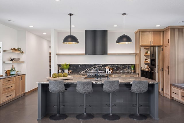 kitchen with concrete flooring, open shelves, a kitchen bar, and light stone counters