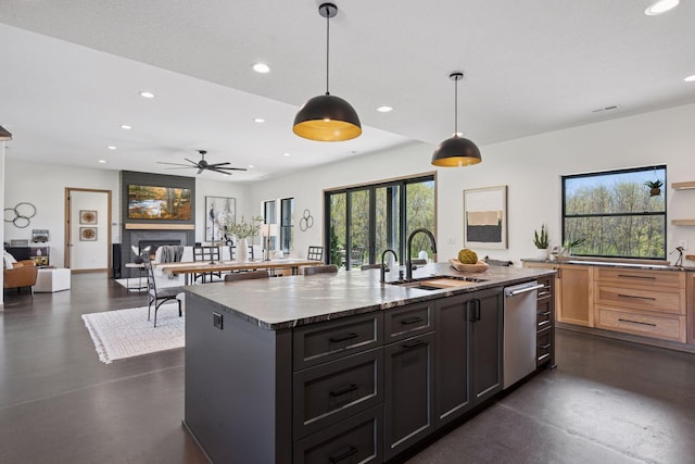 kitchen with a sink, recessed lighting, dishwasher, and concrete floors