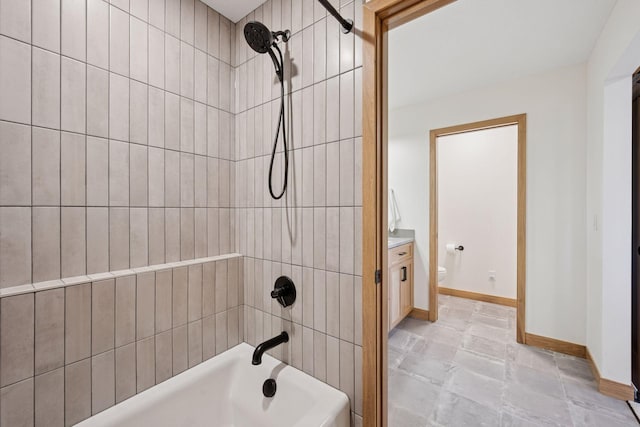 bathroom featuring shower / bathing tub combination, vanity, toilet, and baseboards