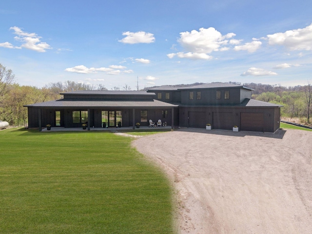 view of front of house with dirt driveway and a front lawn