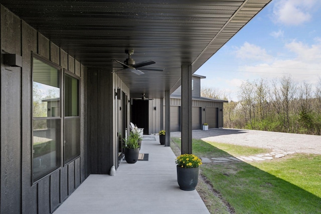 view of patio with a ceiling fan and a garage