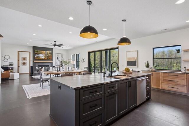 1342 Jansen Ave SE, Hanover, MN 55313 - kitchen featuring finished concrete floors, recessed lighting, stainless steel dishwasher, a fireplace, and an island with sink