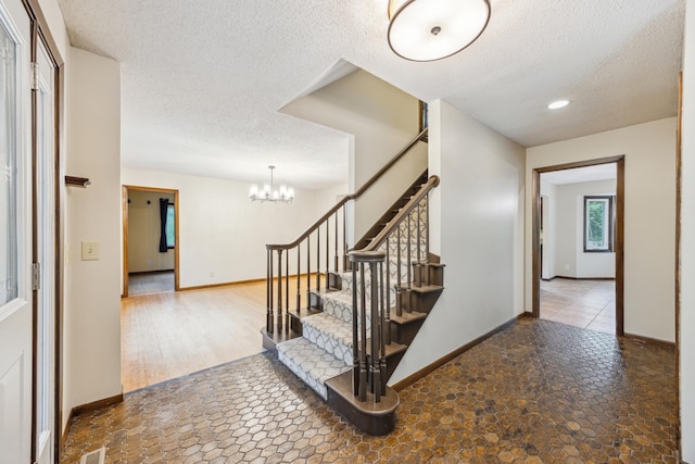 21 Red Fox Rd, North Oaks, MN 55127 - stairway featuring a textured ceiling, baseboards, a chandelier, and recessed lighting