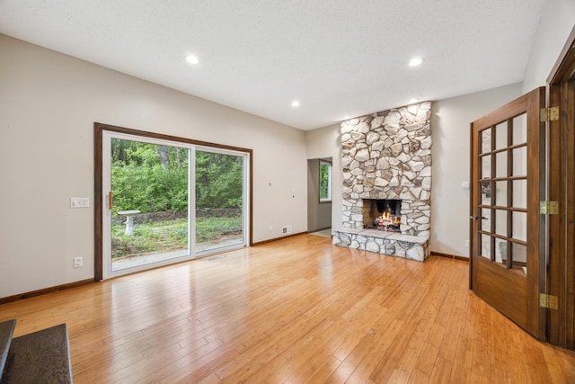 21 Red Fox Rd, North Oaks, MN 55127 - unfurnished living room featuring light wood finished floors, a fireplace, recessed lighting, and baseboards