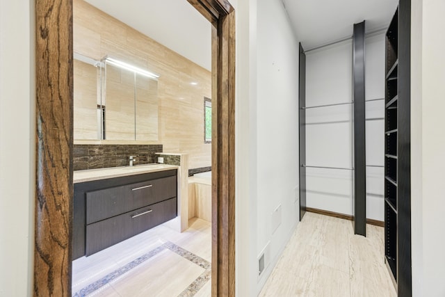 21 Red Fox Rd, North Oaks, MN 55127 - bathroom featuring vanity, a garden tub, and wood finished floors