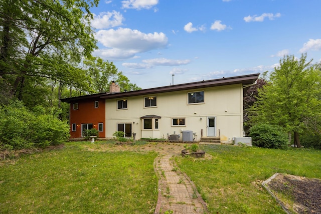 21 Red Fox Rd, North Oaks, MN 55127 - rear view of property with a chimney, a lawn, and cooling unit