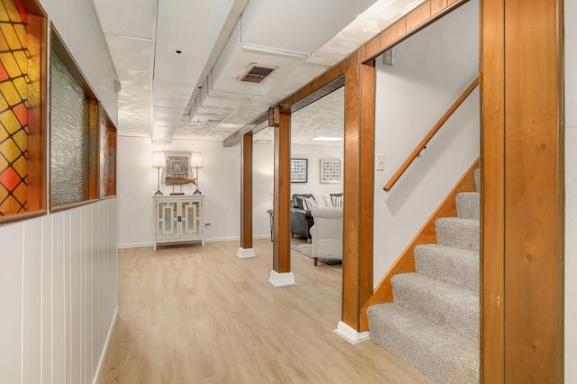 hall featuring stairs, baseboards, visible vents, and light wood-style flooring