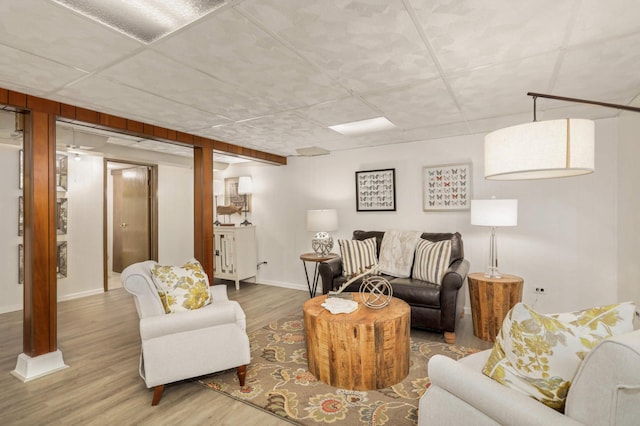 living room with baseboards and wood finished floors