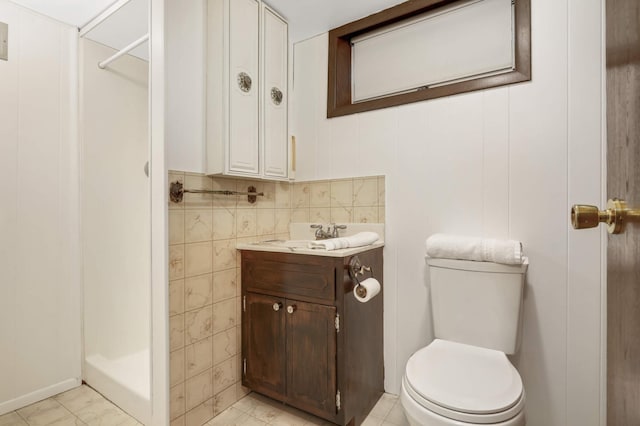 bathroom featuring vanity, a stall shower, and toilet
