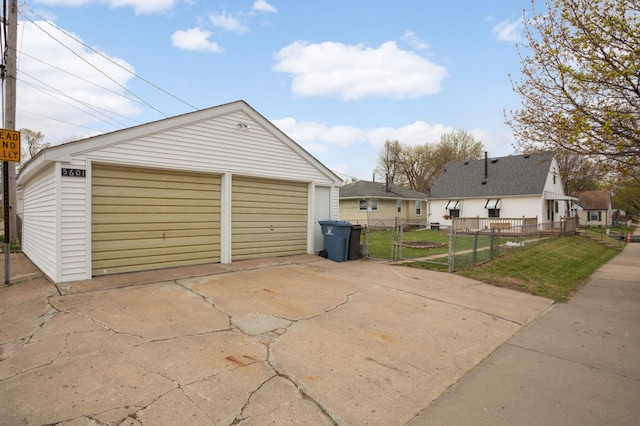 detached garage featuring a gate and fence