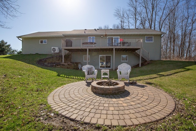 rear view of house with stairs, ac unit, a wooden deck, a lawn, and a patio