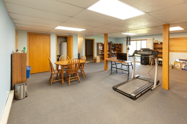 interior space featuring a paneled ceiling and a baseboard heating unit