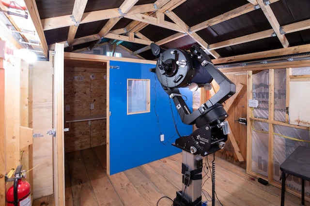 exercise area featuring vaulted ceiling and hardwood / wood-style floors