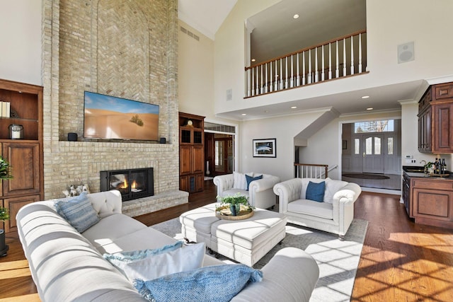 1510 Green Trees Rd, Orono, MN 55391 - living room with a brick fireplace, visible vents, high vaulted ceiling, and wood finished floors