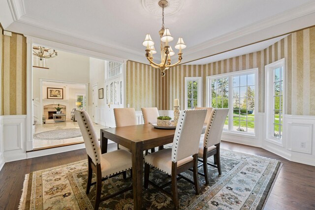1510 Green Trees Rd, Orono, MN 55391 - dining room with wallpapered walls, a chandelier, wainscoting, crown molding, and dark wood-style floors