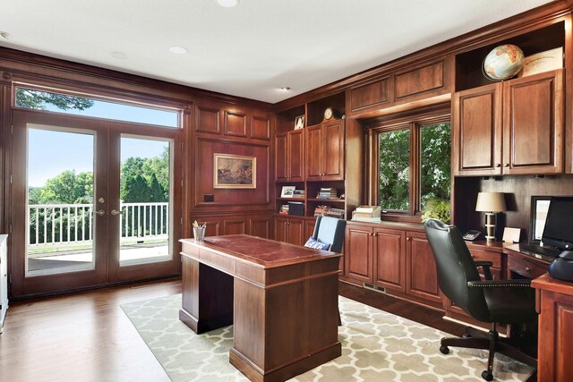 1510 Green Trees Rd, Orono, MN 55391 - home office with healthy amount of natural light, built in desk, and french doors