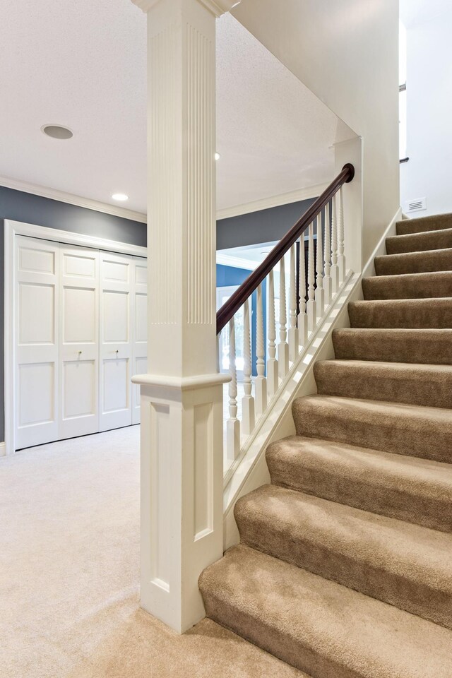 1510 Green Trees Rd, Orono, MN 55391 - stairs featuring carpet, crown molding, and ornate columns