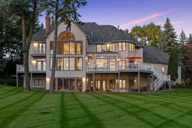 1510 Green Trees Rd, Orono, MN 55391 - rear view of property with stucco siding, a balcony, and a chimney